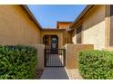 Inviting front entry with iron gate and desert landscaping showcasing great curb appeal at 17891 W Badger Way, Goodyear, AZ 85338