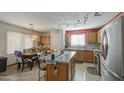 Open kitchen with stainless steel appliances and an island with seating at 1937 W Burgess Ln, Phoenix, AZ 85041