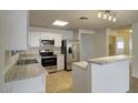 Bright kitchen features stainless steel appliances and white cabinetry at 218 E Milada Dr, Phoenix, AZ 85042