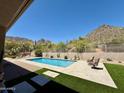 Backyard swimming pool with desert landscaping, patio, and mountain views at 23516 N 119Th Way, Scottsdale, AZ 85255