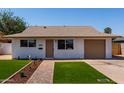 Inviting single-story home with a well-kept front yard and neutral color palette at 2443 E Randall Dr, Tempe, AZ 85288