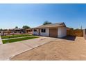 Attractive single-story home featuring a low-maintenance front yard and wide driveway at 2443 E Randall Dr, Tempe, AZ 85288