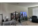 Cozy living room featuring a large television, area rug, and comfortable seating at 25931 W Deer Valley Rd, Buckeye, AZ 85396