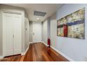 Inviting hallway boasts hardwood floors, neutral paint, and an abstract piece of art at 310 S 4Th St # 1601, Phoenix, AZ 85004