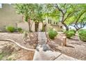 Inviting home exterior featuring a stone staircase, desert landscaping, and mature shade trees at 3131 E Legacy Dr # 1032, Phoenix, AZ 85042