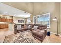 Comfortable living area featuring a large sectional couch, tall ceilings, and bright, natural light at 3131 E Legacy Dr # 1032, Phoenix, AZ 85042