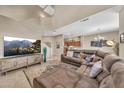 Spacious living room with vaulted ceilings, plush sectional, and a media center with a large screen TV at 3131 E Legacy Dr # 1032, Phoenix, AZ 85042