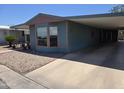 Welcoming single-story home featuring a covered carport and simple rock landscaping at 3330 E Main St # 121, Mesa, AZ 85213