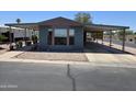 Charming single-story home featuring a covered carport and low-maintenance rock landscaping at 3330 E Main St # 121, Mesa, AZ 85213