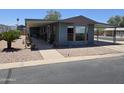 Attractive home showcasing an extended covered patio, carport, and desert-friendly landscaping at 3330 E Main St # 121, Mesa, AZ 85213