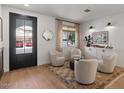 Stylishly decorated living room offering wood floors, neutral paint, designer fixtures, and a large picture window at 3523 E Alfalfa Dr, Gilbert, AZ 85298