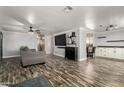 Spacious living room showcasing a large TV, modern furniture, and luxury vinyl plank flooring at 3807 W Abraham Ln, Glendale, AZ 85308