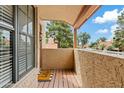 Private balcony featuring desert views, a welcome mat, wood flooring and exterior lattice window screens at 4901 E Kelton Ln # 1270, Scottsdale, AZ 85254