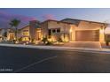 Inviting exterior of a single-story home with stone accents and a convenient two-car garage at 5218 N Tiller Dr, Litchfield Park, AZ 85340