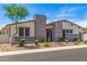 Attractive single-story home featuring stone details, desert landscaping, and meticulous design at 5218 N Tiller Dr, Litchfield Park, AZ 85340