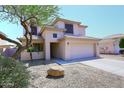 Charming two-story home features a spacious driveway and well-maintained desert landscaping at 537 S 153Rd Ln, Goodyear, AZ 85338