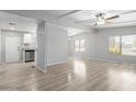Open living space with new floors, a ceiling fan, and abundant natural light, offering a welcoming atmosphere at 5436 E Aspen E Ave, Mesa, AZ 85206