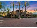 Luxury apartment complex with palm trees and brick driveway showcasing a well-maintained exterior at 5450 E Deer Valley Dr # 2191, Phoenix, AZ 85054