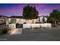 Charming home with modern landscaping, decorative wall, and trees providing excellent curb appeal at 5707 N 12Th Pl, Phoenix, AZ 85014
