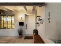 Inviting front porch with white door, decorative planters, and a welcome mat at 5707 N 12Th Pl, Phoenix, AZ 85014