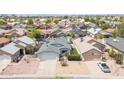 An aerial view showcasing the home nestled in a neighborhood with well-maintained landscaping and surrounding residences at 6938 W Nicolet Ave, Glendale, AZ 85303