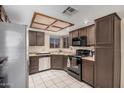 Functional kitchen with tile flooring, ample cabinet space, and modern appliances at 7426 W Cholla St, Peoria, AZ 85345