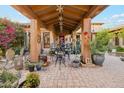 Relaxing courtyard featuring a beautiful seating area, desert landscaping, hanging decor, and stunning desert sunsets at 7846 E Wilderness Trl, Gold Canyon, AZ 85118