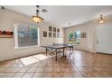 Spacious game room with tile floors, natural light, and ping pong table at 8968 W Adam Ave, Peoria, AZ 85382