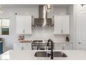 Close up of a bright and modern kitchen with stainless steel appliances and plenty of counter space at 9764 E Thornbush Ave, Mesa, AZ 85212