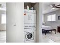 Efficient laundry area featuring a stacked washer and dryer conveniently located near the bedroom at 14404 N Boxwood Ln, Fountain Hills, AZ 85268