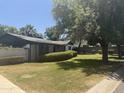 Charming single story home featuring mature trees, large lawn and privacy bushes at 1447 E Town And Country Ln, Phoenix, AZ 85014