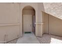 Entrance with a white front door, decorative archway, and address number at 15050 N Thompson Peak Pkwy # 1001, Scottsdale, AZ 85260