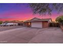View of a charming single-story home with a two-car garage and low maintenance gravel landscaping at 17220 N 55Th Ave, Glendale, AZ 85308