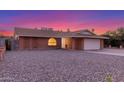 Charming single-story brick home featuring a two-car garage and low-maintenance gravel front yard at 17220 N 55Th Ave, Glendale, AZ 85308