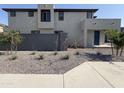 Stylish home showcasing desert landscaping, stucco facade, and a block wall at 17989 W Lupine Ave, Goodyear, AZ 85338