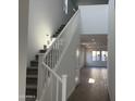 Bright foyer featuring high ceilings and a stairway leading to the upper level at 17989 W Lupine Ave, Goodyear, AZ 85338