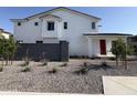 Charming two-story home boasts a red front door and desert landscaping at 18061 W Lupine Ave, Goodyear, AZ 85338