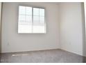 Bright bedroom featuring neutral carpet, base-molding and a large window at 18250 N Cave Creek Rd # 123, Phoenix, AZ 85032