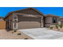 Charming single-story home featuring a low maintenance yard and a two-car garage at 18374 W Poston Dr, Surprise, AZ 85387
