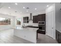 Contemporary kitchen with a center island, stainless steel appliances, dark wood cabinets, and abundant recessed lighting at 21845 E Bonanza Ct, Queen Creek, AZ 85142