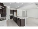 Bright, open kitchen showcasing a center island with bar seating, sleek stainless steel appliances, and ample cabinet space at 21845 E Bonanza Ct, Queen Creek, AZ 85142