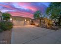 Attractive home featuring stone accents on the facade, desert landscaping, and a spacious three-car garage at 22847 N 53Rd E St, Phoenix, AZ 85054