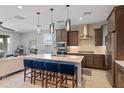 Stylish kitchen with stainless steel appliances, pendant lighting, and seating at the island at 24226 N 22Nd St, Phoenix, AZ 85024