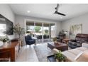 Comfortable living room with a ceiling fan, sliding glass doors, and a view of the backyard patio at 24226 N 22Nd St, Phoenix, AZ 85024