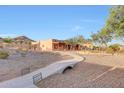 Exterior view of desert home, showcasing landscaping and winding sidewalk at 28758 N Ashbrook Ln, San Tan Valley, AZ 85144