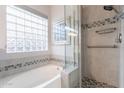 Bright bathroom featuring a tub and separate shower with decorative tile accents at 3055 N Red Mtn # 122, Mesa, AZ 85207