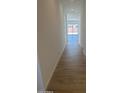 Bright hallway with light wood floors leading to a spacious living area with lots of natural light at 3637 E Rochelle Cir, Mesa, AZ 85213