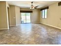 Spacious living room featuring tile floors and a sliding glass door leading to the backyard at 4117 W Allen St, Laveen, AZ 85339