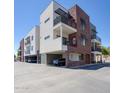 Modern multi-story building featuring balconies, red brick accents, and convenient parking at 475 N 9Th St # 303, Phoenix, AZ 85006