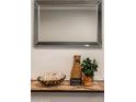 Close-up of console table with mirror and decorative elements in the entryway at 4932 E Kathleen Rd, Scottsdale, AZ 85254